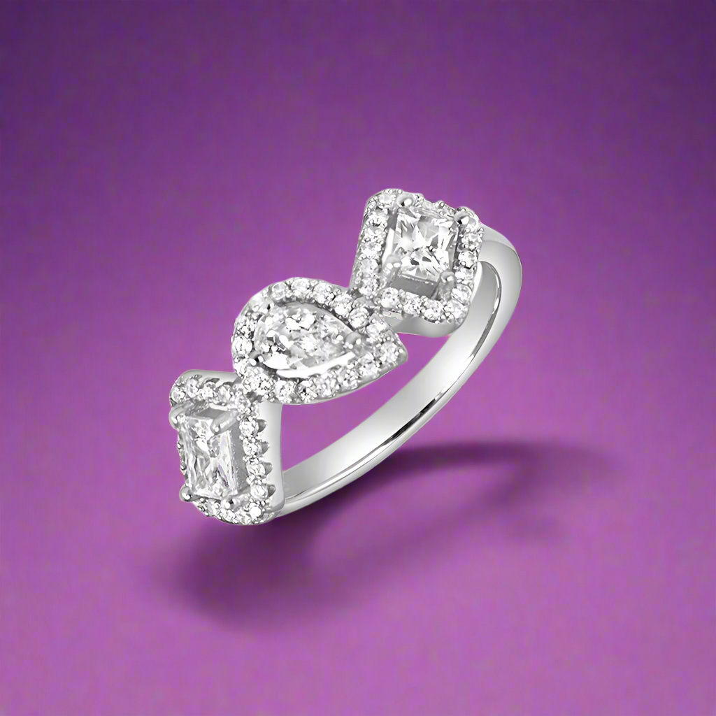 A silver ring with a solitaire diamond centerpiece surrounded by smaller cubic zirconia stones set in a classic six-prong setting.