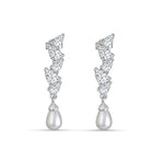 Load image into Gallery viewer, Pair of silver earrings with teardrop-shaped pearls on a white background
