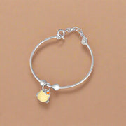 Silver baby bracelet with a yellow charm on a white background