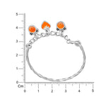Load image into Gallery viewer, Silver bracelet with orange stones on a white background with a ruler for scale.
