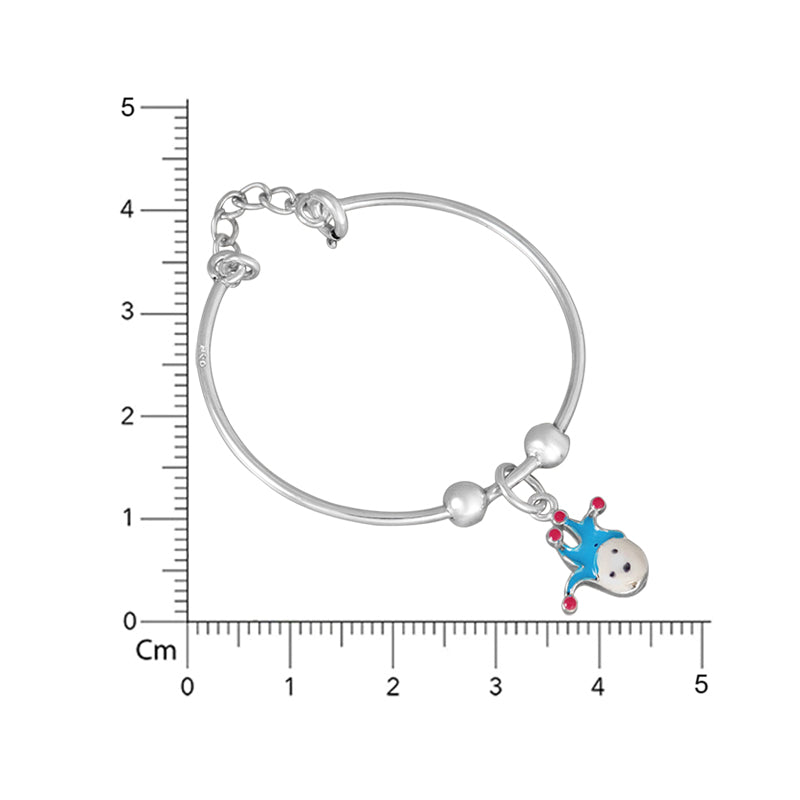 Silver bracelet with a small blue and red charm on a white background with a ruler for scale.