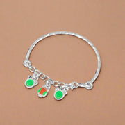 A silver kids' bracelet with green and orange accents designed for newborns to 3 years old.