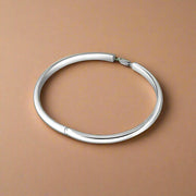 A 925 silver bracelet with a simple design, circular in shape and crafted for children.