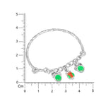 Load image into Gallery viewer, Silver bracelet with charms on a white background with a ruler for scale.
