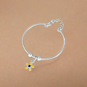 A silver bracelet featuring a floral pattern with a central flower charm, designed for kids.
