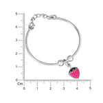 Load image into Gallery viewer, Silver bracelet with a heart-shaped charm on a white background with a ruler for scale.
