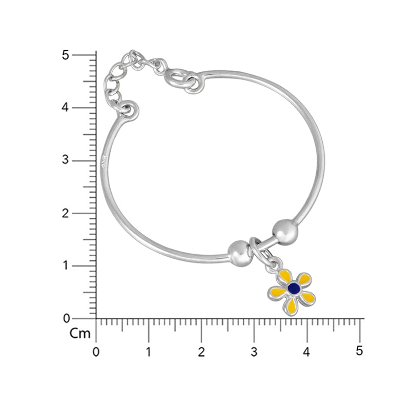 Silver bracelet with a flower charm on a white background with measurement scale