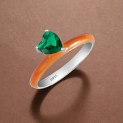 A sterling silver ring with a heart-shaped enamel design and a cubic zirconia centerpiece.