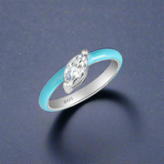 A sterling silver ring with a blue enamel band and a central cubic zirconia.