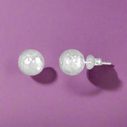 A pair of sterling silver stud earrings with a dazzling effect, featuring a smooth and polished finish.