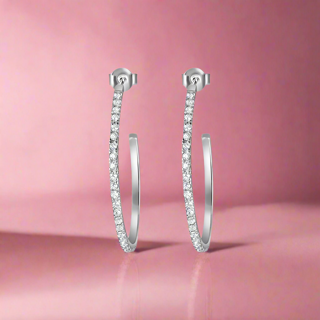 A pair of 925 sterling silver hoop earrings with intricate detailing, presented against a white background.