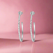 A pair of 925 sterling silver hoop earrings with intricate detailing, presented against a white background.