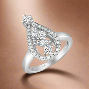 A sterling silver ring with a central pear-shaped cubic zirconia surrounded by smaller round cubic zirconia stones, set on a white background.
