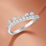 A sterling silver ring with a band of AAA cubic zirconia stones set around its circumference.