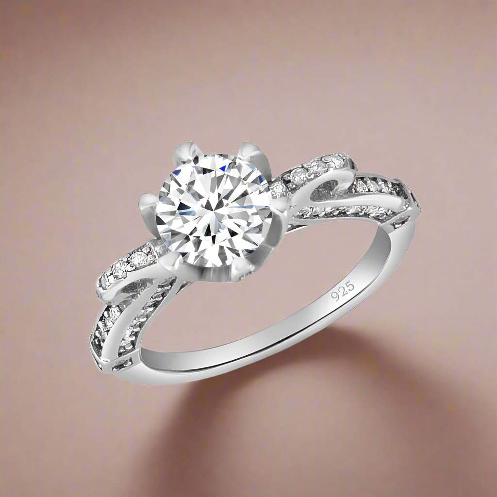 A sterling silver ring with a central cubic zirconia stone and smaller stones on the band.