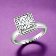 A sterling silver solitaire ring with a clear, AAA cubic zirconia center stone surrounded by smaller clear stones.