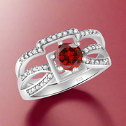 A 925 sterling silver twin bridal ring with a red cubic zirconia centerpiece.