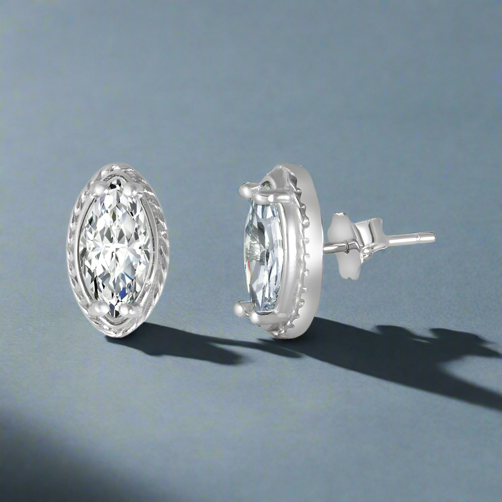A pair of sterling silver earrings with a marquise shape and a cubic zirconia center, displayed against a white background.