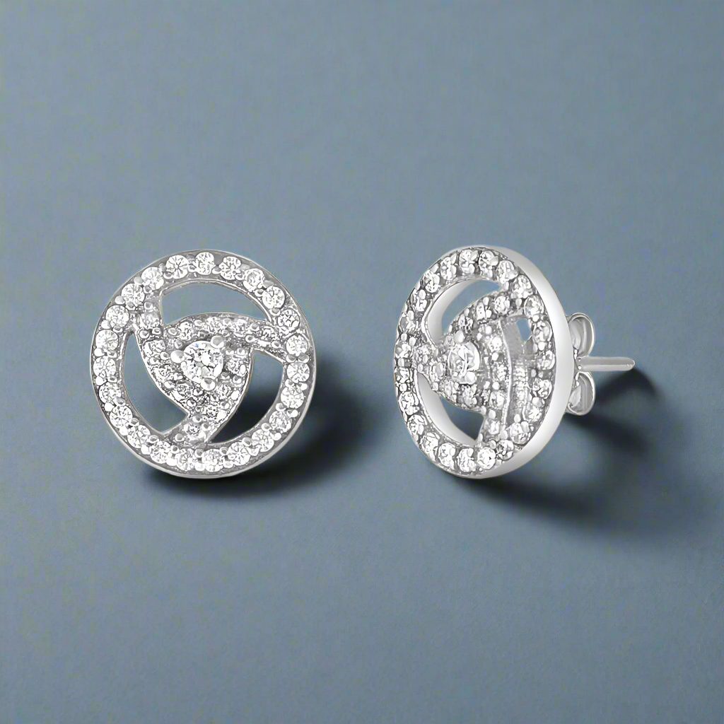 A pair of sterling silver earrings with a central cubic zirconia surrounded by smaller clear crystals, set in rose gold-colored settings.