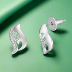 Load image into Gallery viewer, A pair of sterling silver earrings with a geometric heart design and cubic zirconia embellishments.
