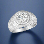 Apollo 925 Sterling Silver Men's Ring with a single large cubic zirconia surrounded by smaller cubic zircons, set in a white gold-colored band.