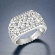 A men's sterling silver ring with a geometric pattern of cubic zirconia stones set in a white gold-colored band.