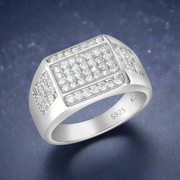 A men's sterling silver ring with a block of cubic zirconia stones set on top, surrounded by smaller clear stones.