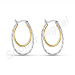 Load image into Gallery viewer, Pair of hoop earrings with gold and silver finish on a white background
